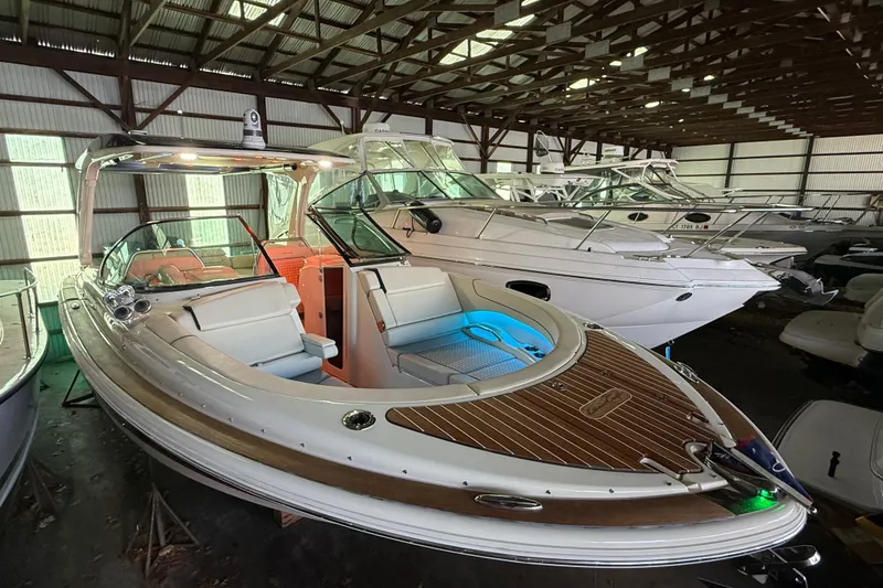 Slide: The Image of 2021 Chris-Craft Launch 31 GT boat in storage, featuring elegant design and wood accents. - 4