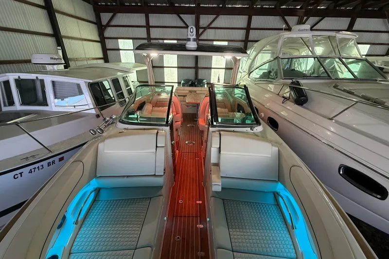 Slide: The Image of 2021 Chris-Craft Launch 31 GT in a boat storage facility, showcasing elegant interior lighting. - 9