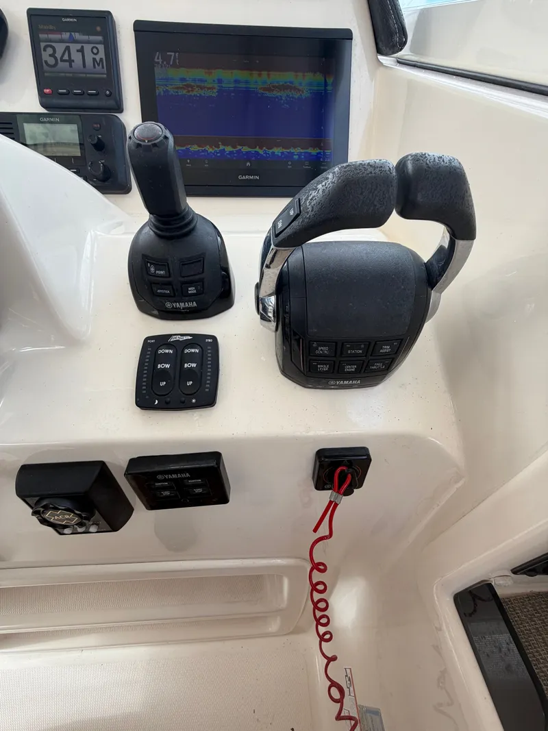 Slide: The Image of 2019 Grady-White Freedom 307 boat with twin outboard engines. - 12