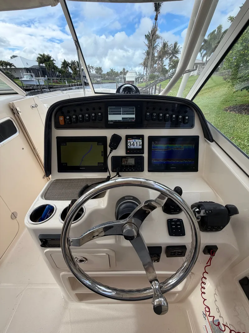 Slide: The Image of 2019 Grady-White Freedom 307 boat docked at marina. - 8
