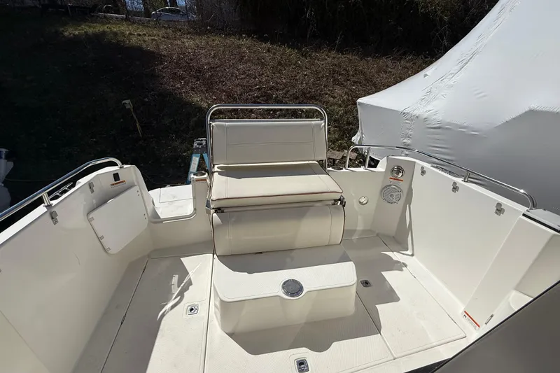 Slide: The Image of 2016 Cutwater 24 boat interior with white seating and clean deck design. - 10