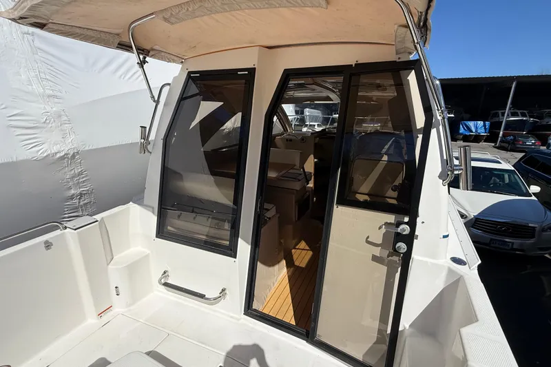 Slide: The Image of 2016 Cutwater 24 boat with open cabin door, showcasing interior and exterior features. - 18