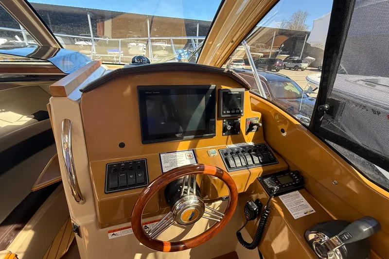 Slide: The Image of Interior view of a 2016 Cutwater 24 boat cockpit with steering wheel and control panel. - 27
