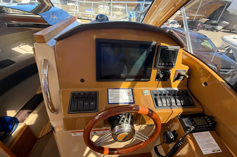 Slide: The Image of Helm of 2016 Cutwater 24 boat with navigation controls and steering wheel. - 30
