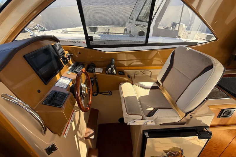 Slide: The Image of Interior helm of 2016 Cutwater 24 boat with steering wheel and navigation controls. - 31