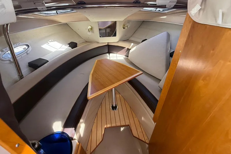 Slide: The Image of 2016 Cutwater 24 boat interior with wood accents and seating area. - 33