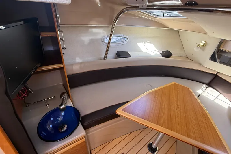 Slide: The Image of Interior of a 2016 Cutwater 24 boat with seating, table, and sink. - 34