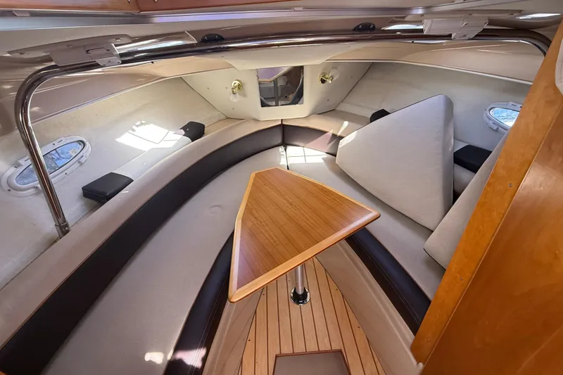 Slide: The Image of Interior of a 2016 Cutwater 24 boat with seating and wooden table. - 35