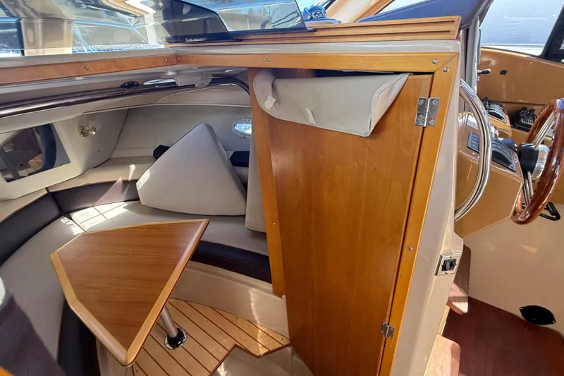 Slide: The Image of Interior of 2016 Cutwater 24 boat with wooden table and seating area. - 36