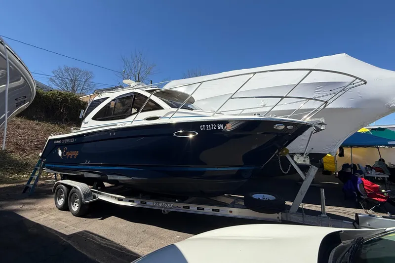 Slide: The Image of 2016 Cutwater 24 boat on trailer under canopy, parked outdoors. - 4