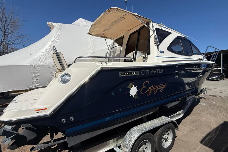 Slide: The Image of 2016 Cutwater 24 boat on trailer, featuring "Enjoyage" text on the side. - 5