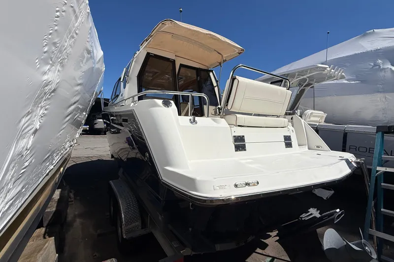 Slide: The Image of 2016 Cutwater 24 boat rear view, docked with cover, sunny day. - 7