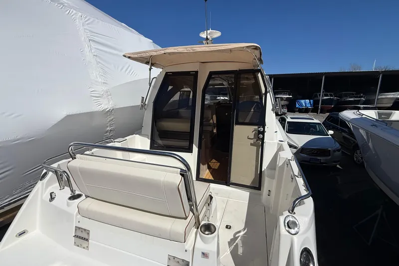 Slide: The Image of 2016 Cutwater 24 boat with open cabin door, docked in a marina. - 9