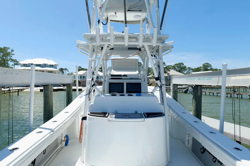 Slide: The Image of 2018 Yellowfin 36 Offshore boat docked, featuring a sleek white design and advanced navigation equipment. - 13