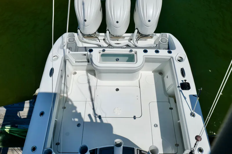 Slide: The Image of 2018 Yellowfin 36 Offshore boat with triple engines, spacious deck, and fishing amenities. - 15