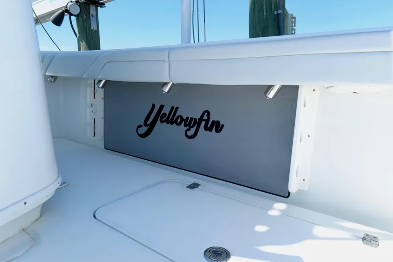 Slide: The Image of 2018 Yellowfin 36 Offshore boat interior with logo, white seating, and clean design. - 17