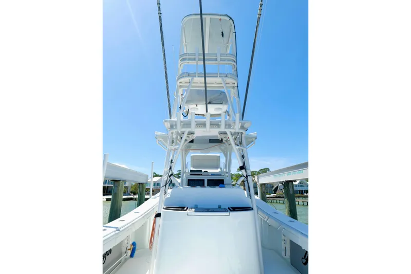 Slide: The Image of 2018 Yellowfin 36 Offshore boat with tower, docked under clear blue sky. - 2