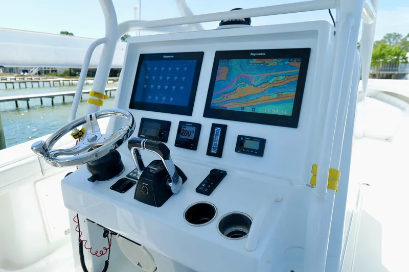 Slide: The Image of 2018 Yellowfin 36 Offshore boat dashboard with dual Raymarine displays and steering wheel. - 24