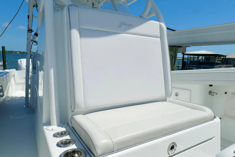 Slide: The Image of 2018 Yellowfin 36 Offshore boat seat with cup holders, docked by the water. - 26