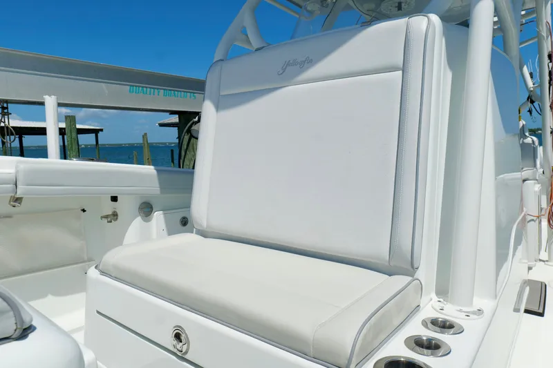 Slide: The Image of 2018 Yellowfin 36 Offshore boat interior with white seating and cup holders. - 28