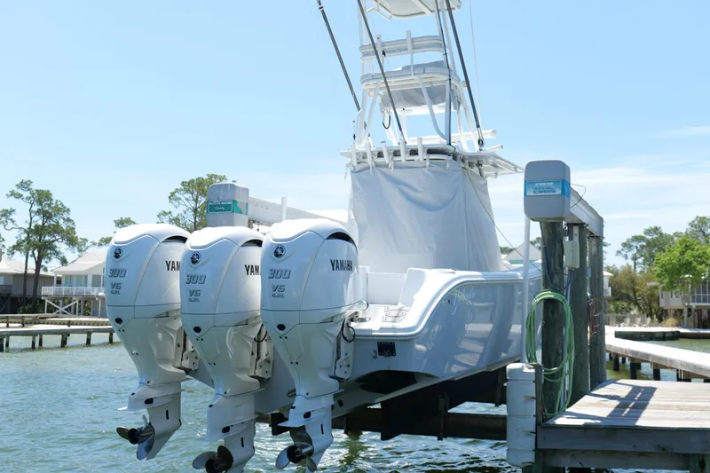 Slide: The Image of 2018 Yellowfin 36 Offshore boat with triple Yamaha 300 V6 engines docked by the water. - 3