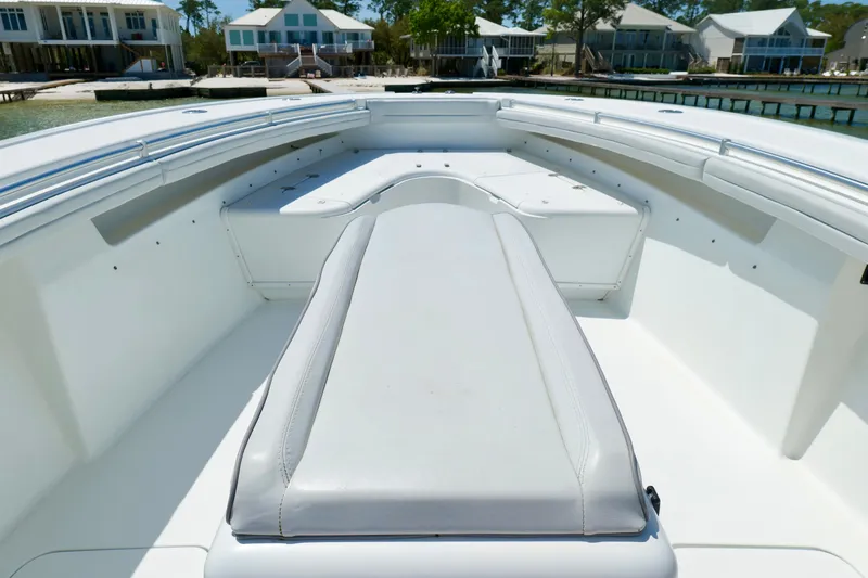 Slide: The Image of 2018 Yellowfin 36 Offshore boat interior with cushioned seating, dockside view. - 31