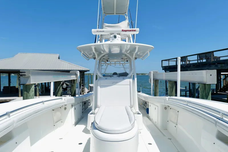 Slide: The Image of 2018 Yellowfin 36 Offshore boat docked, showcasing sleek design and advanced navigation equipment. - 32