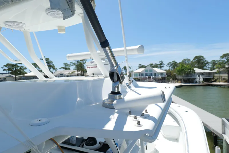 Slide: The Image of 2018 Yellowfin 36 Offshore boat with Raymarine equipment, docked near waterfront homes. - 35