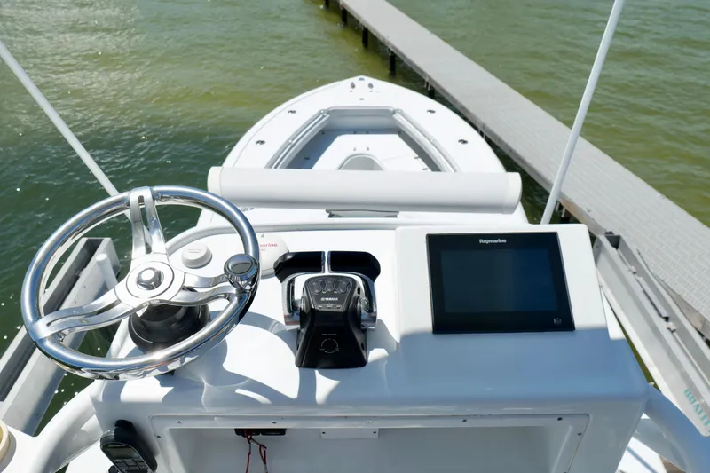 Slide: The Image of 2018 Yellowfin 36 Offshore boat helm with steering wheel and navigation display. - 4