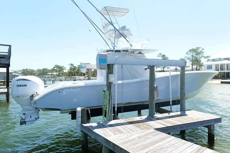 Slide: The Image of 2018 Yellowfin 36 Offshore boat docked with Yamaha engines, in a serene waterfront setting. - 5