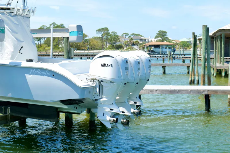 Slide: The Image of 2018 Yellowfin 36 Offshore boat with triple Yamaha engines docked by the water. - 8