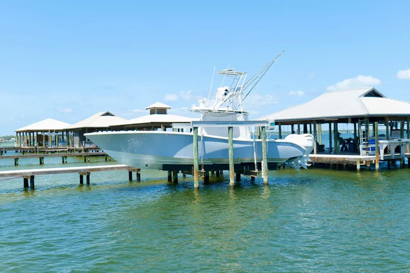 Slide: The Image of 2018 Yellowfin 36 Offshore boat docked at marina, clear blue sky background. - 9