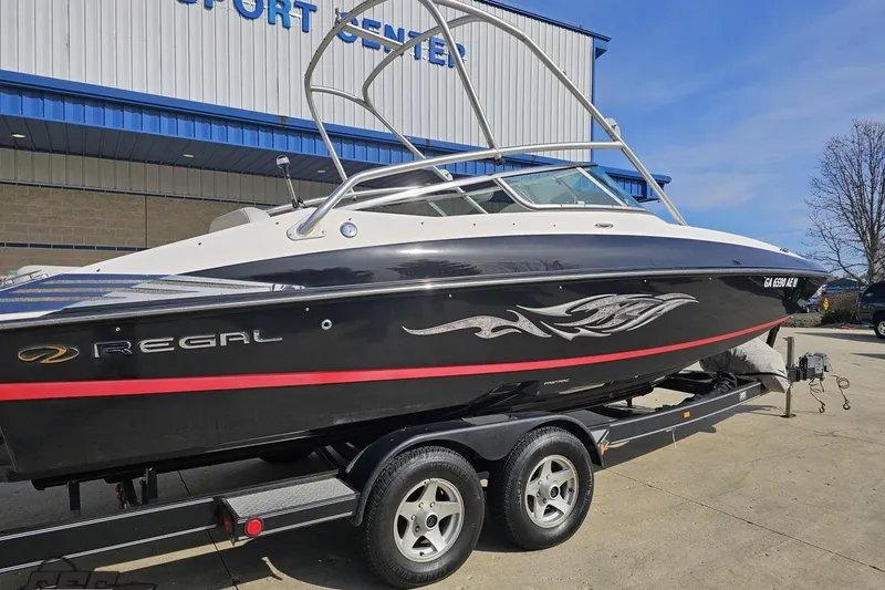 Slide: The Image of 2008 Regal 2520 FasDeck boat on trailer outside a sport center. - 10