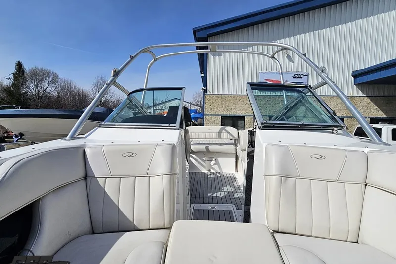 Slide: The Image of 2008 Regal 2520 FasDeck boat with white interior, parked outdoors near a building. - 101