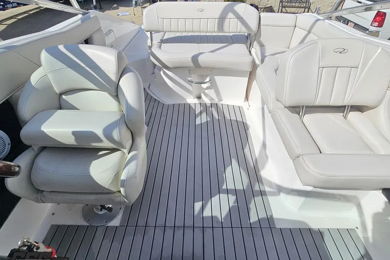 Slide: The Image of Interior of a 2008 Regal 2520 FasDeck boat with white seating and gray flooring. - 103