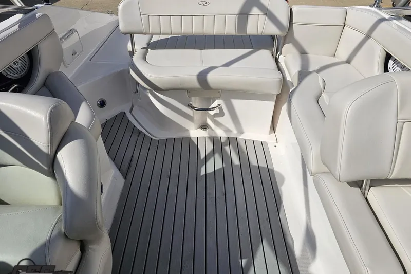 Slide: The Image of Interior of 2008 Regal 2520 FasDeck boat with white seating and gray flooring. - 104