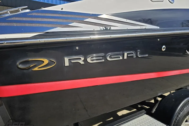 Slide: The Image of 2008 Regal 2520 FasDeck boat with sleek black and red design. - 12