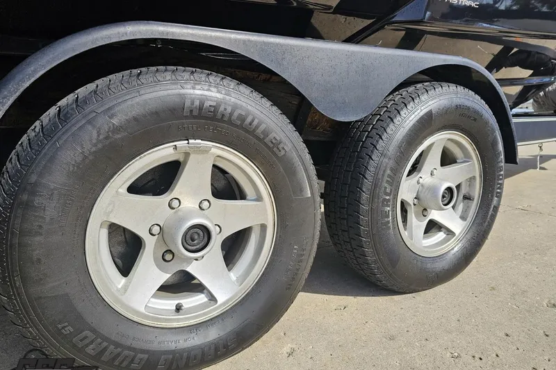 Slide: The Image of Trailer wheels of a 2008 Regal 2520 FasDeck boat on concrete surface. - 14