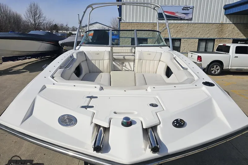 Slide: The Image of 2008 Regal 2520 FasDeck boat with spacious seating, docked outdoors. - 20