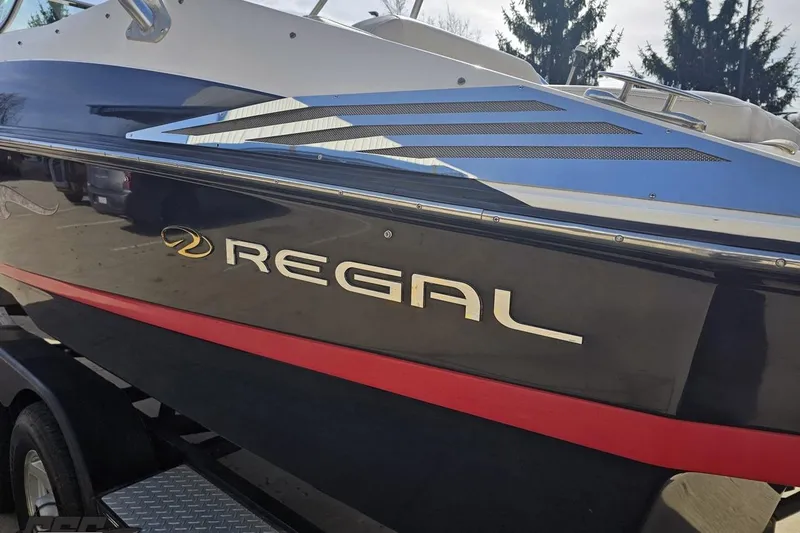 Slide: The Image of 2008 Regal 2520 FasDeck boat with sleek black and red design. - 29