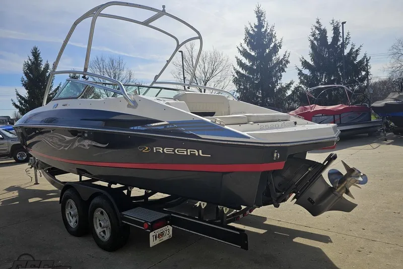 Slide: The Image of 2008 Regal 2520 FasDeck boat on trailer, parked outdoors under clear sky. - 33