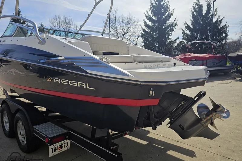 Slide: The Image of 2008 Regal 2520 FasDeck boat on trailer, showcasing sleek design and powerful engine. - 34