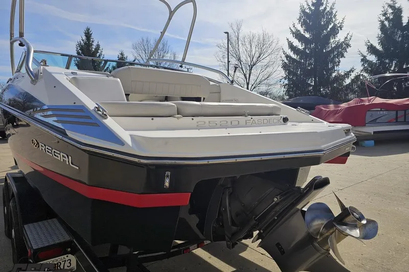 Slide: The Image of 2008 Regal 2520 FasDeck boat on trailer, rear view with propeller visible. - 35