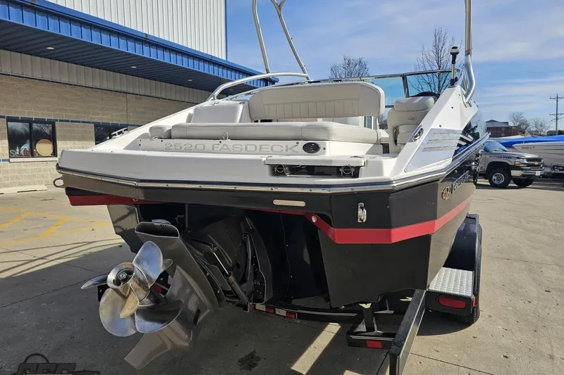 Slide: The Image of 2008 Regal 2520 FasDeck boat on trailer, rear view, showcasing propeller and seating. - 39