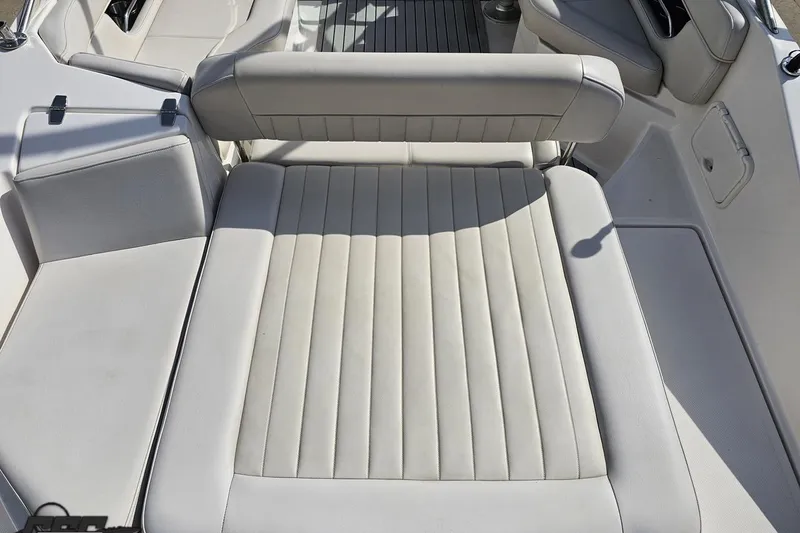 Slide: The Image of Interior seating of a 2008 Regal 2520 FasDeck boat, featuring plush white upholstery. - 41