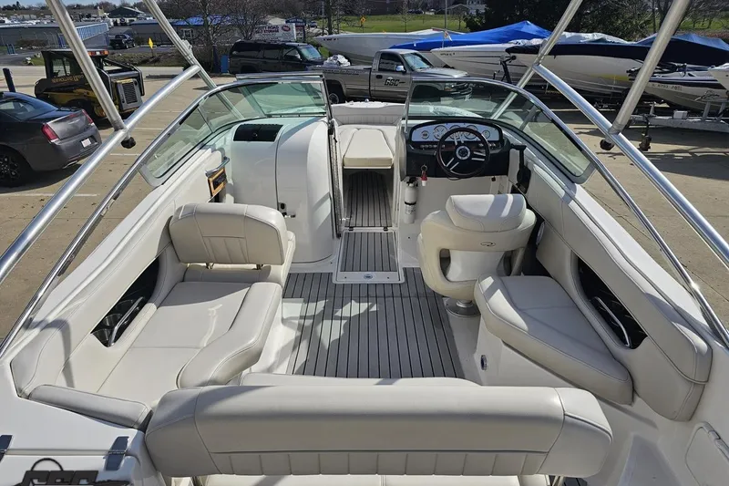 Slide: The Image of 2008 Regal 2520 FasDeck boat interior with white seating and steering console. - 44