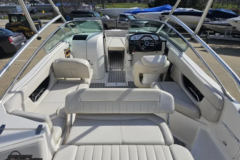 Slide: The Image of Interior of a 2008 Regal 2520 FasDeck boat with white seating and steering console. - 46