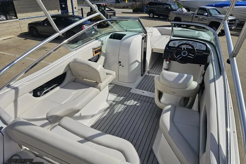 Slide: The Image of Interior of a 2008 Regal 2520 FasDeck boat with white seating and steering console. - 50