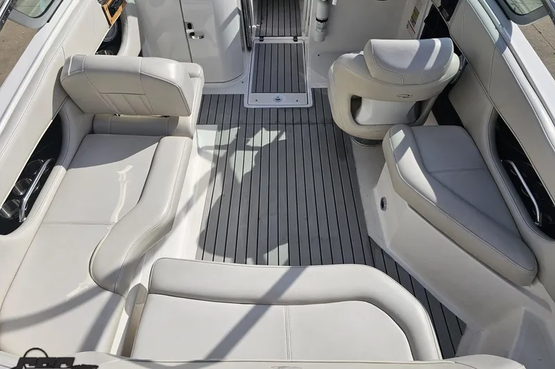 Slide: The Image of Interior of a 2008 Regal 2520 FasDeck boat with white seating and gray flooring. - 52