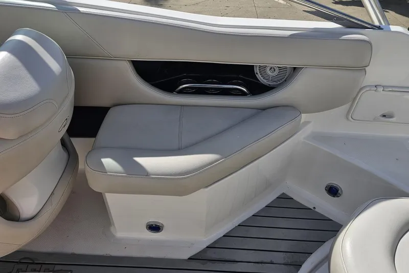 Slide: The Image of Interior seating of a 2008 Regal 2520 FasDeck boat, featuring white upholstery and sleek design. - 53